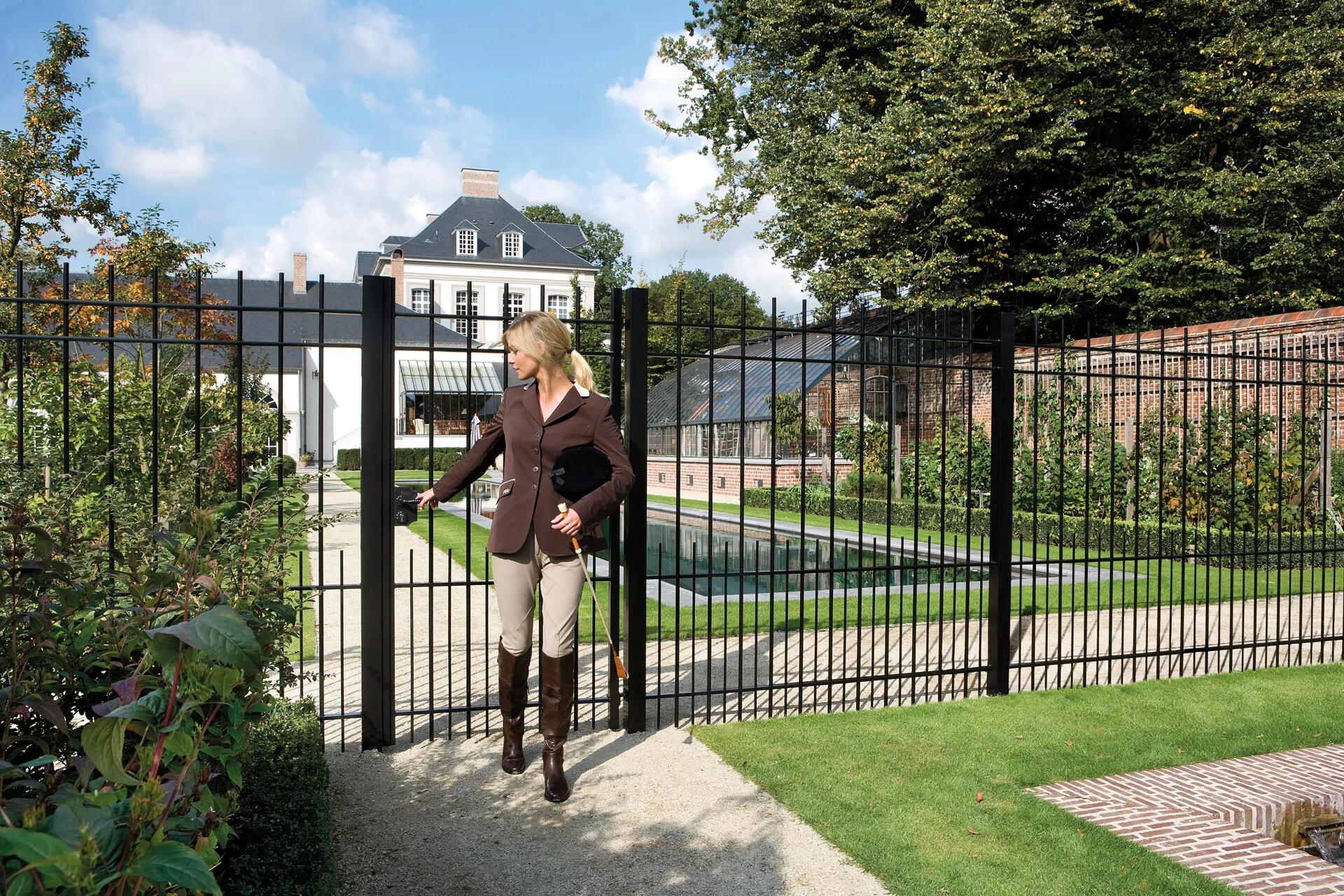 Lakq H2 Gbm U18 Spkz  Equestrian Leaving Black Ornamental Gate at Villa  1920px